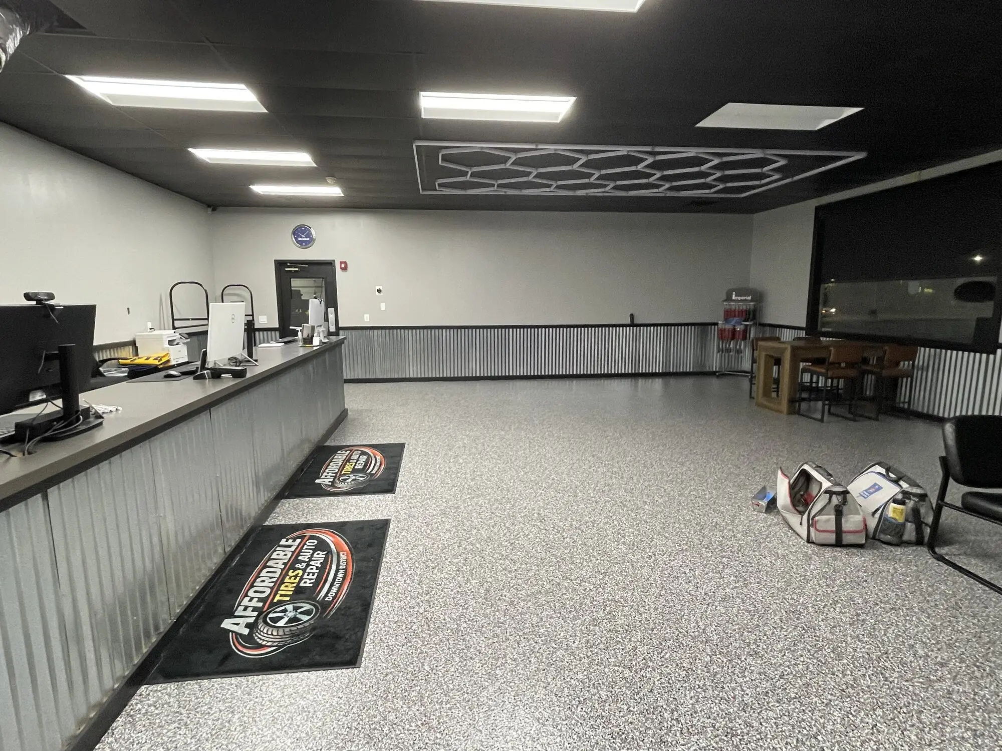 Commercial service counter and waiting area with fresh white walls and a speckled floor
